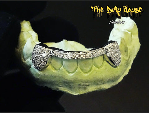 2 iced out teeth with bar